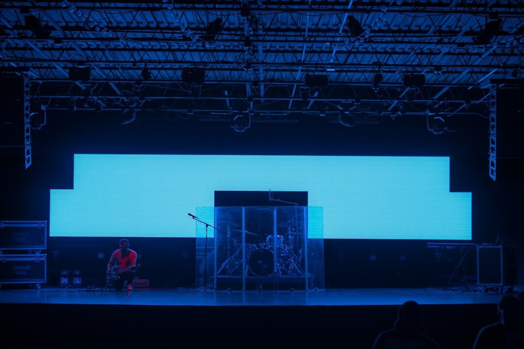 Live event production with dramatic stage lighting and audience