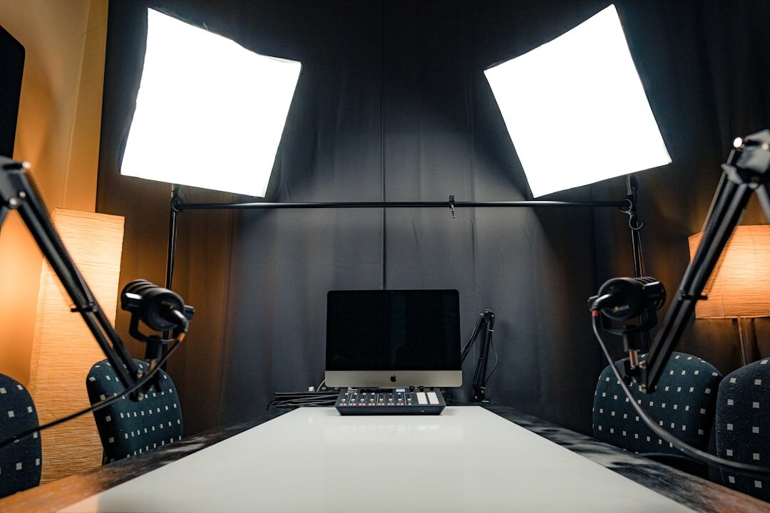 Modern broadcast studio interior with workstations and screens